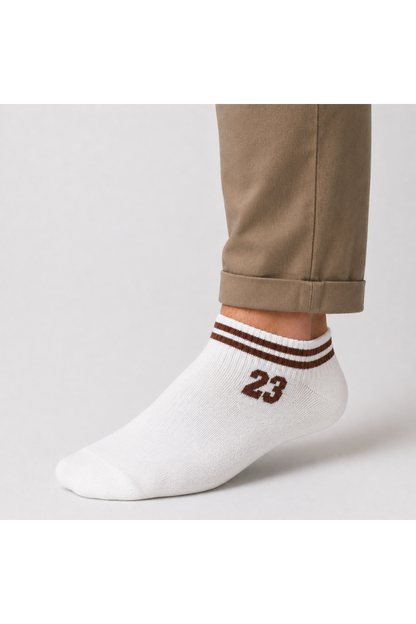 Rodi machine White ankle sock with brown stripes and number 23 worn by a person with beige pants on a light gray background